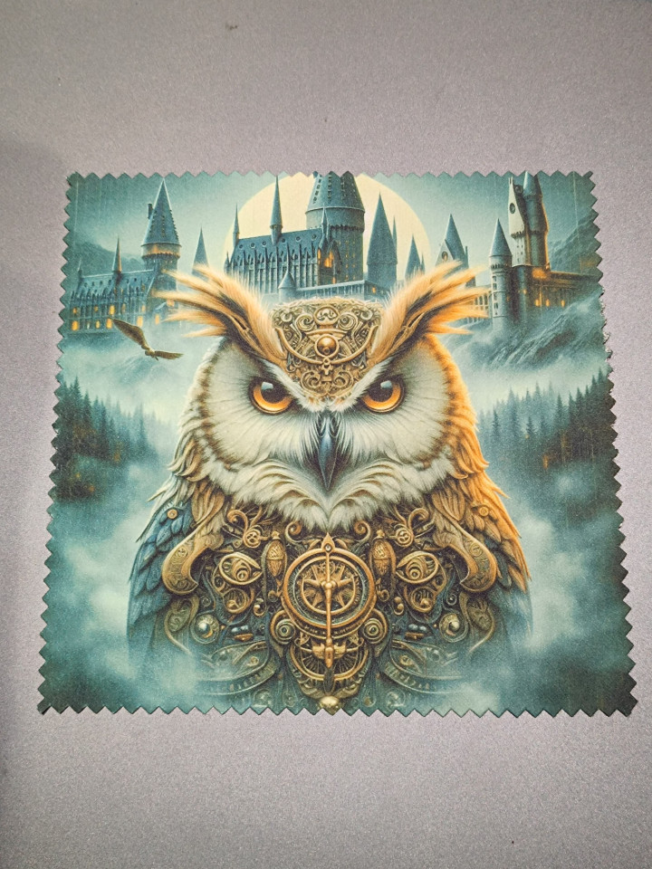 Lingette microfibre montrant un hibou aux yeux dorés orné de parures devant un château brumeux