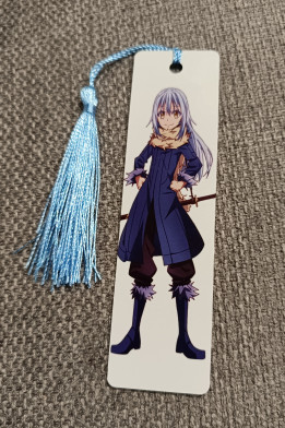 Marque-page blanc illustré d'un personnage de manga aux cheveux bleus avec pompon bleu ciel
