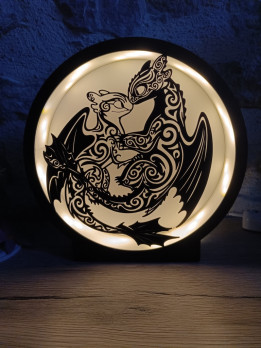 Lampe ronde lumineuse avec silhouette noire de deux dragons face à face