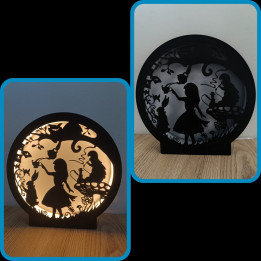 Lampe veilleuse ronde noire avec silhouettes féeriques découpées allumée et éteinte
