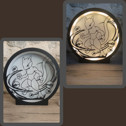 Lampe veilleuse circulaire noire avec silhouette de créature fantastique et orbes, vue éteinte et allumée