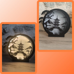 Lampe veilleuse ronde noire avec découpe silhouette de pagode et de pin, allumée et éteinte