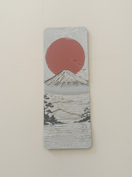 Marque-page en relief représentant une montagne enneigée sous un soleil rouge
