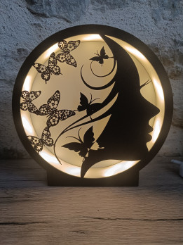Lampe ronde noire avec silhouette de femme et papillons rétroéclairée par LED