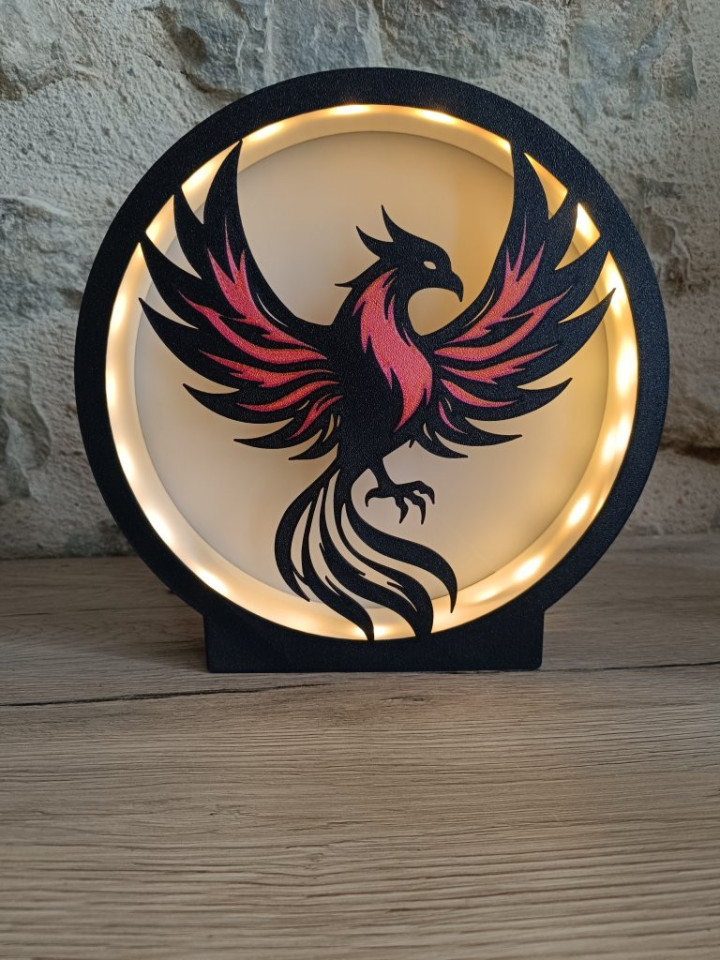 Lampe circulaire noire représentant la silhouette d'un phénix avec éclairage LED chaleureux