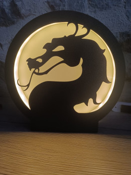 Lampe circulaire noire représentant une silhouette de dragon rétroéclairée par une douce lumière LED